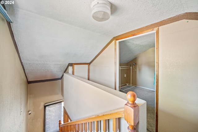 stairway featuring vaulted ceiling