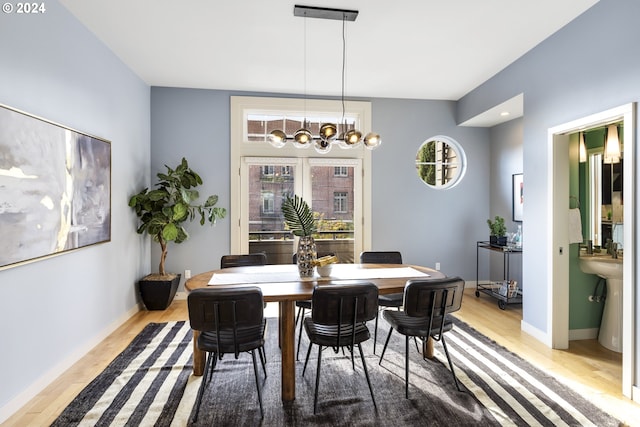 dining room with a notable chandelier and light hardwood / wood-style floors