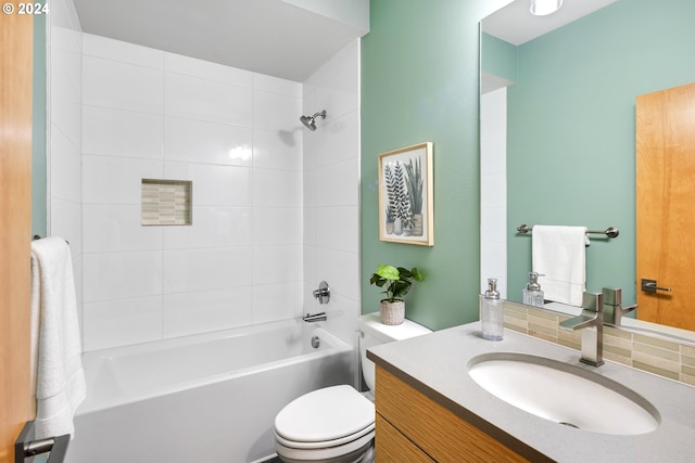 full bathroom with toilet, vanity, tasteful backsplash, and tiled shower / bath