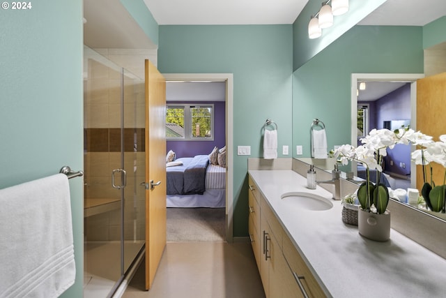 bathroom with a shower with door and vanity