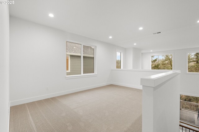 empty room featuring light colored carpet