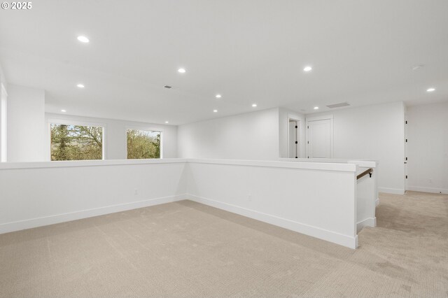 unfurnished room featuring light colored carpet