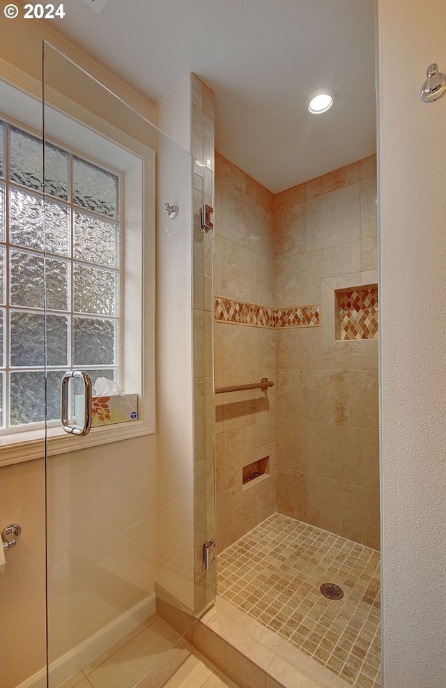 bathroom featuring tile patterned floors and an enclosed shower