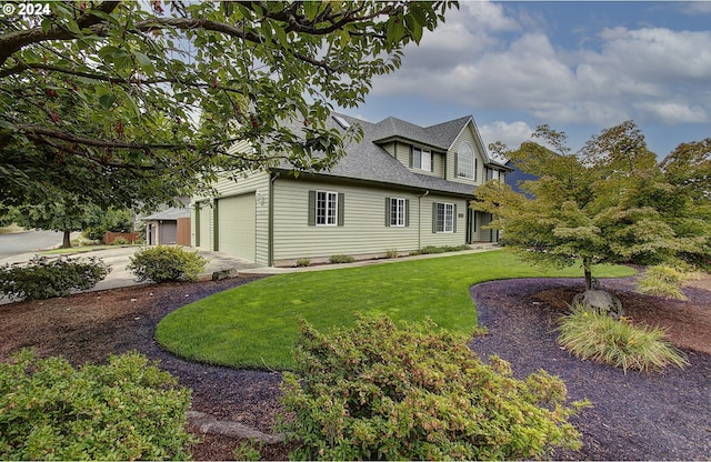 view of front facade featuring a garage and a front lawn