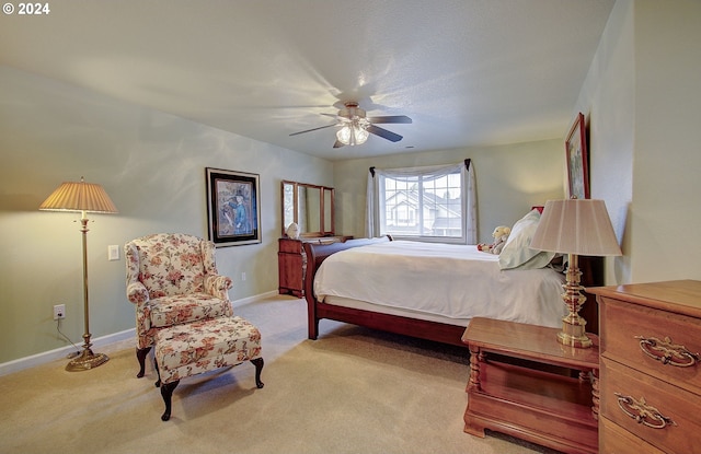 bedroom featuring light carpet and ceiling fan