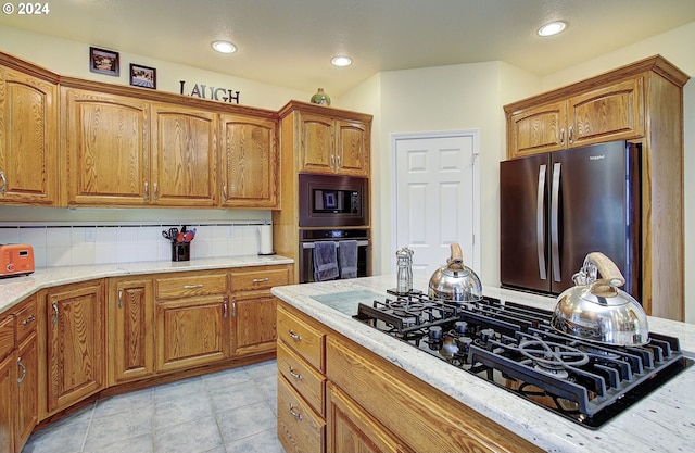 kitchen featuring black appliances and decorative backsplash