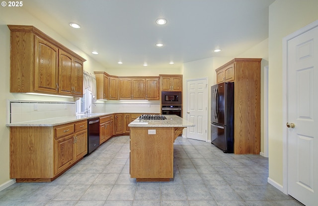 kitchen featuring a breakfast bar, a center island, stainless steel appliances, and sink