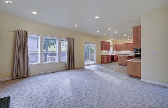 unfurnished living room with light colored carpet