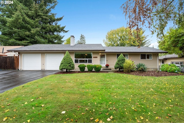 ranch-style home featuring a garage and a front lawn