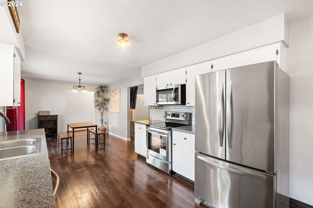 kitchen with sink, appliances with stainless steel finishes, white cabinets, and dark hardwood / wood-style flooring