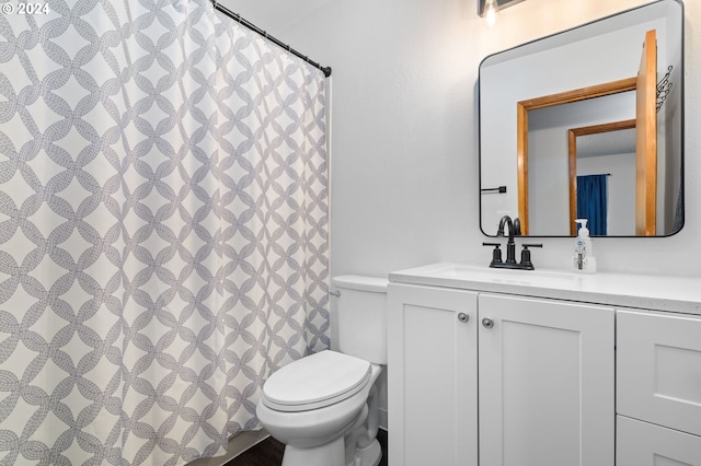 bathroom featuring toilet and vanity