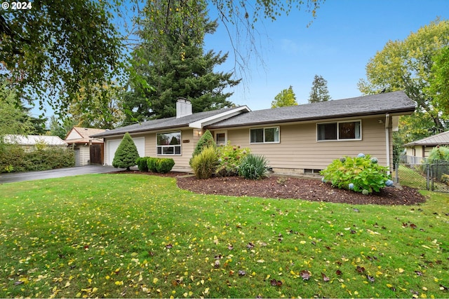 ranch-style home with a front lawn and a garage