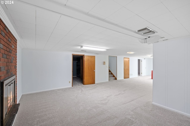 basement with a fireplace and carpet flooring