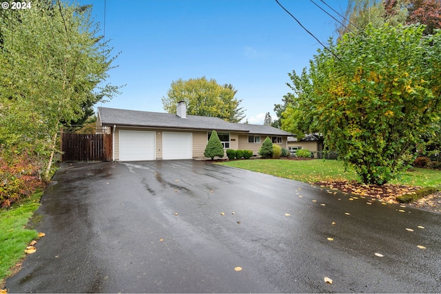 view of front of home featuring a front yard and a garage