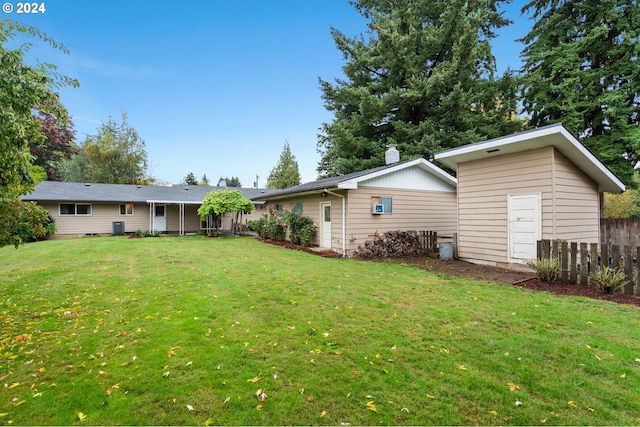 rear view of property with a yard