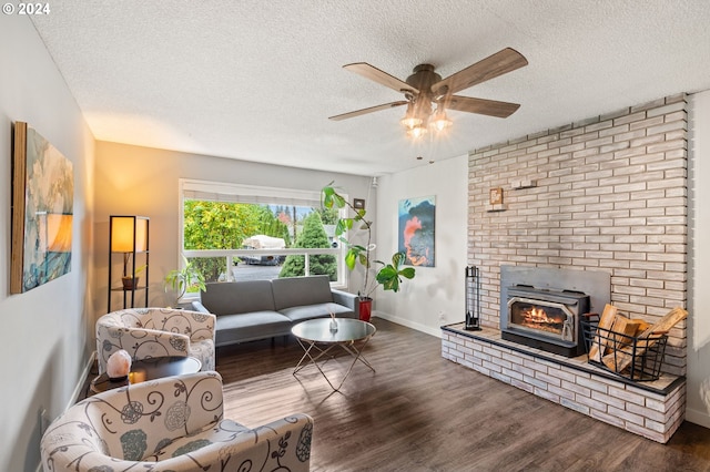 living room with dark wood-type flooring, a textured ceiling, and ceiling fan