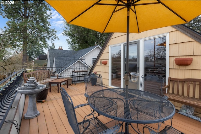 wooden terrace featuring outdoor dining area