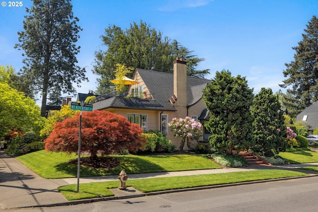 2130 NE Klickitat St, Portland, OR 97212 - view of front of home with a front yard, a chimney, and stucco siding
