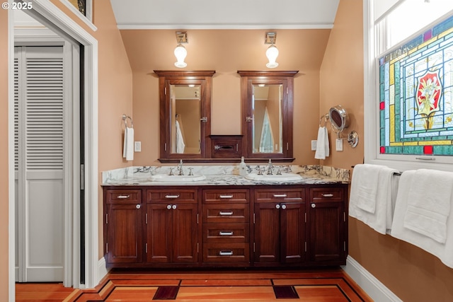 2130 NE Klickitat St, Portland, OR 97212 - bathroom featuring double vanity, wood finished floors, baseboards, and a closet