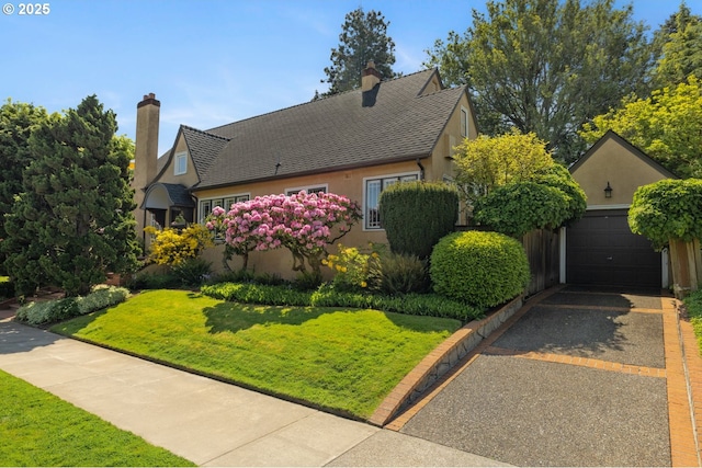 2130 NE Klickitat St, Portland, OR 97212 - view of front of house with stucco siding, a garage, a front lawn, and asphalt driveway