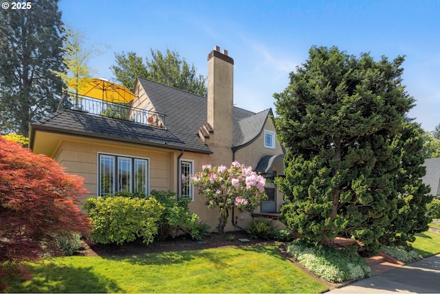 2130 NE Klickitat St, Portland, OR 97212 - view of front of house featuring a balcony, a front yard, and a chimney