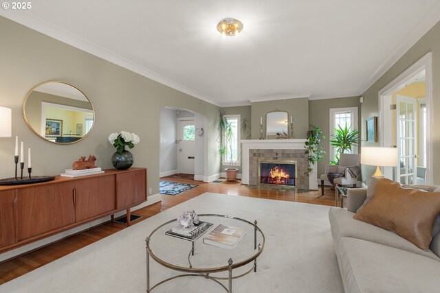 2130 NE Klickitat St, Portland, OR 97212 - living area with wood finished floors, arched walkways, a fireplace, crown molding, and baseboards