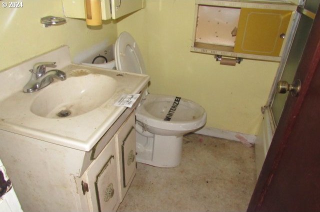 bathroom featuring vanity and toilet