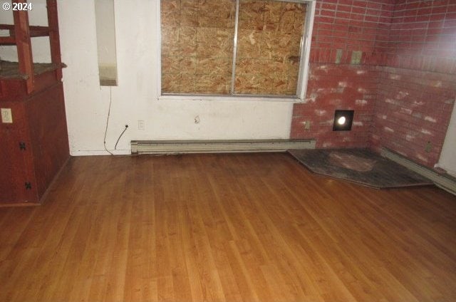 spare room with wood-type flooring