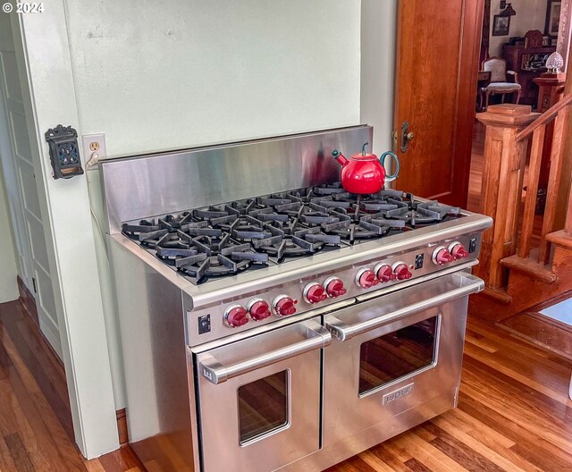 kitchen featuring range with two ovens and hardwood / wood-style floors