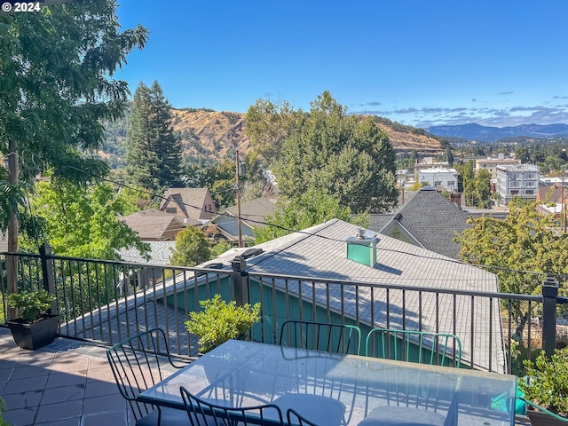 view of patio / terrace featuring a mountain view and outdoor dining space