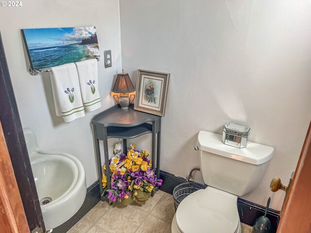 bathroom with tile patterned flooring and toilet