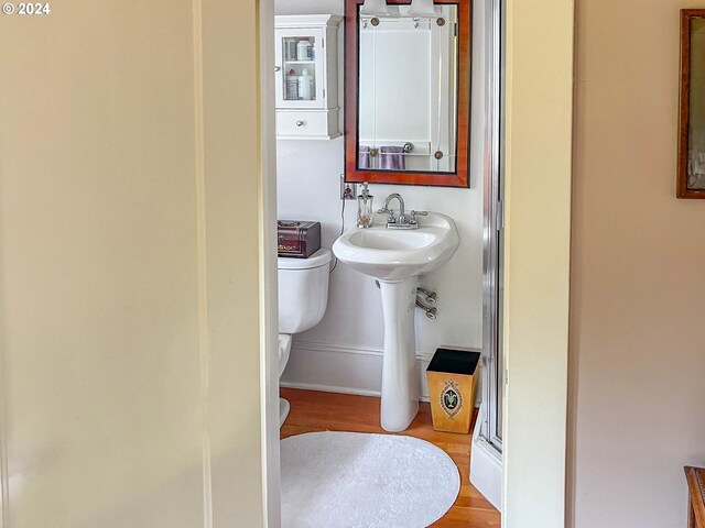 bathroom featuring toilet and hardwood / wood-style flooring