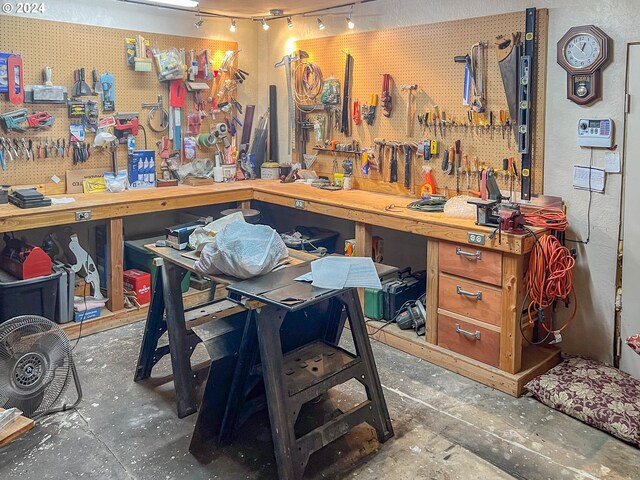 miscellaneous room featuring concrete flooring and a workshop area