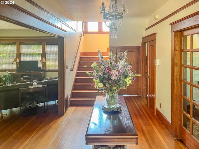 interior space with wood-type flooring and an inviting chandelier