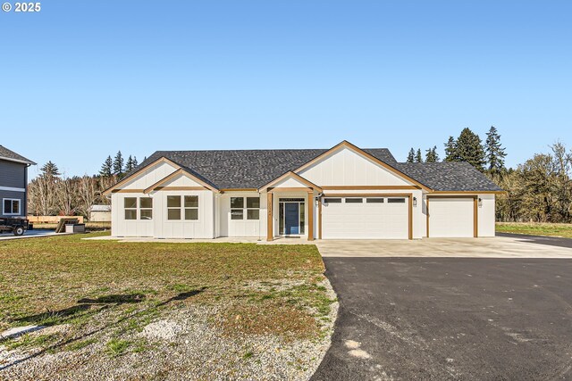 single story home with a front yard and a garage