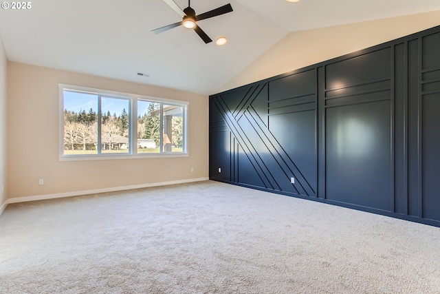 unfurnished bedroom with ceiling fan, vaulted ceiling, and light carpet