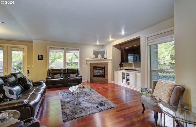 living room featuring dark hardwood / wood-style flooring, a textured ceiling, and french doors