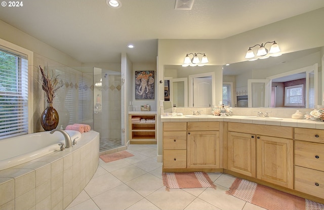 bathroom with shower with separate bathtub, vanity, and tile patterned floors