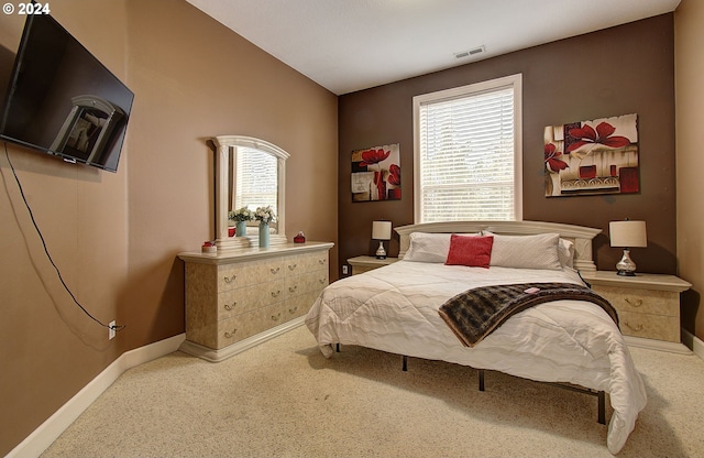 carpeted bedroom featuring multiple windows