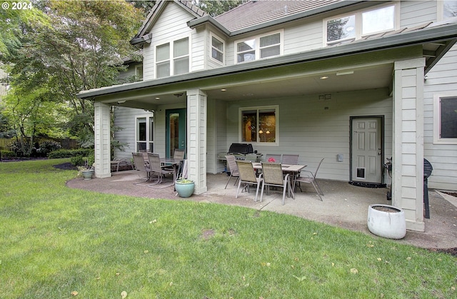 rear view of house with a yard and a patio