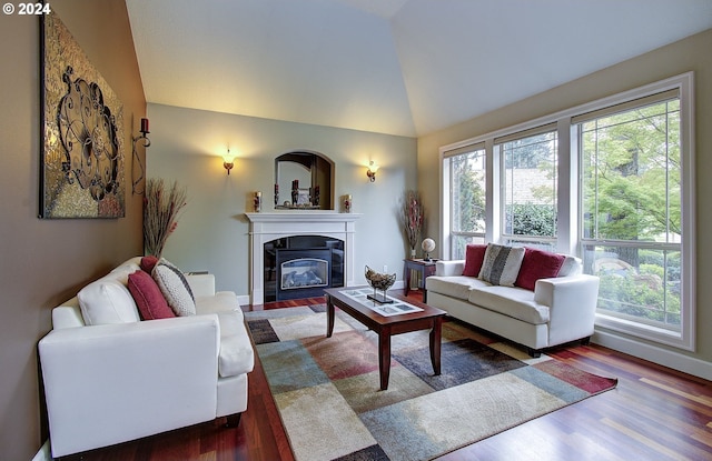 living room featuring dark hardwood / wood-style flooring, plenty of natural light, and lofted ceiling