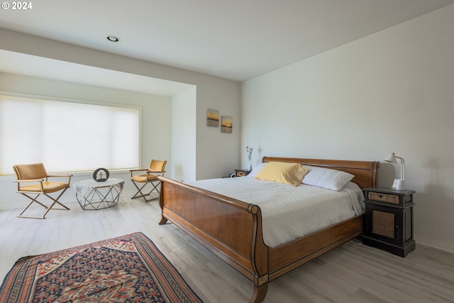 bedroom with wood finished floors and baseboards