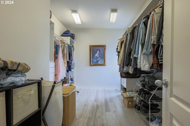 walk in closet featuring wood finished floors