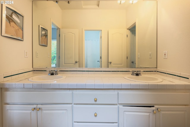 bathroom with double vanity and a sink