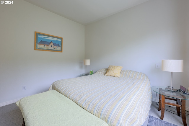 bedroom featuring carpet and baseboards