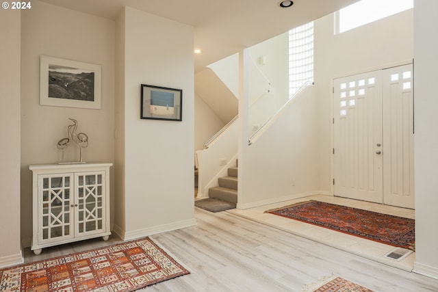 entrance foyer featuring stairway, wood finished floors, visible vents, baseboards, and recessed lighting