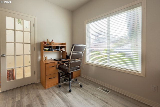 office space featuring visible vents, baseboards, and light wood-style flooring