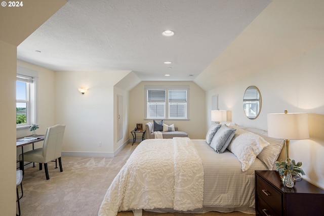 bedroom featuring light carpet and lofted ceiling