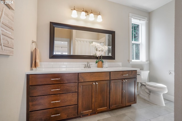 bathroom with toilet, vanity, tile patterned floors, and a shower with shower curtain