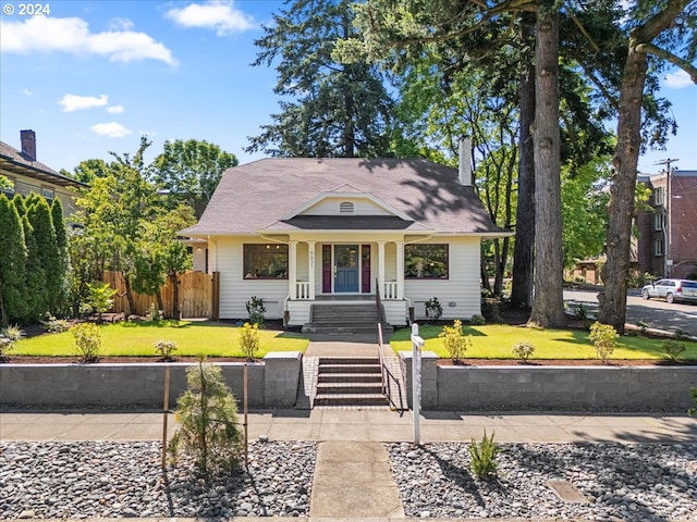 bungalow-style house with a front yard and a porch